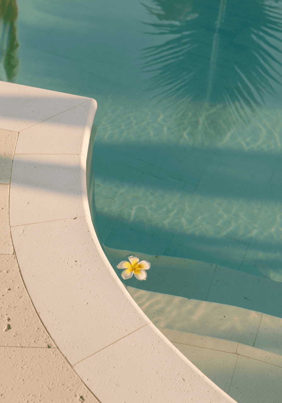 An infinity pool corner with a single floating frangipani